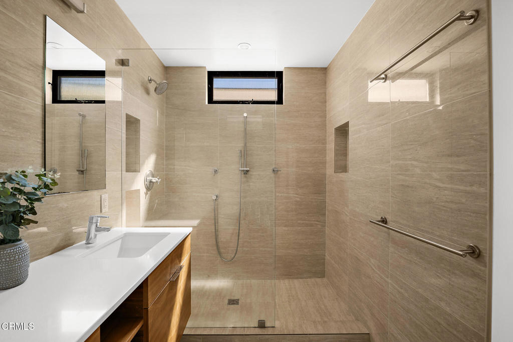 1881 Tulane Avenue Long Beach, CA 90815 - Photo 30 of 51 a bathroom with a sink a glass door shower and a mirror