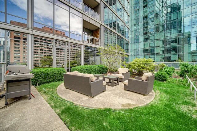 a view of a house with couches chairs and a yard