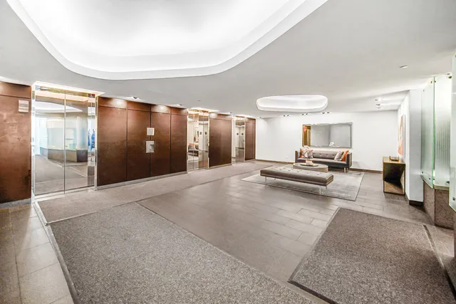 a view of a hall way with furniture