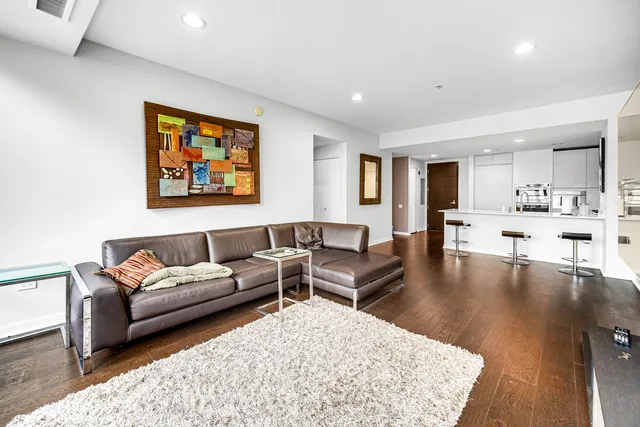 a living room with furniture and a kitchen view