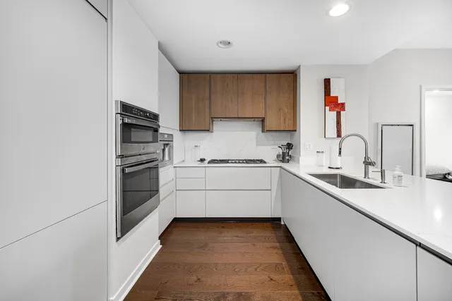 a kitchen with granite countertop a sink and white stainless steel appliances