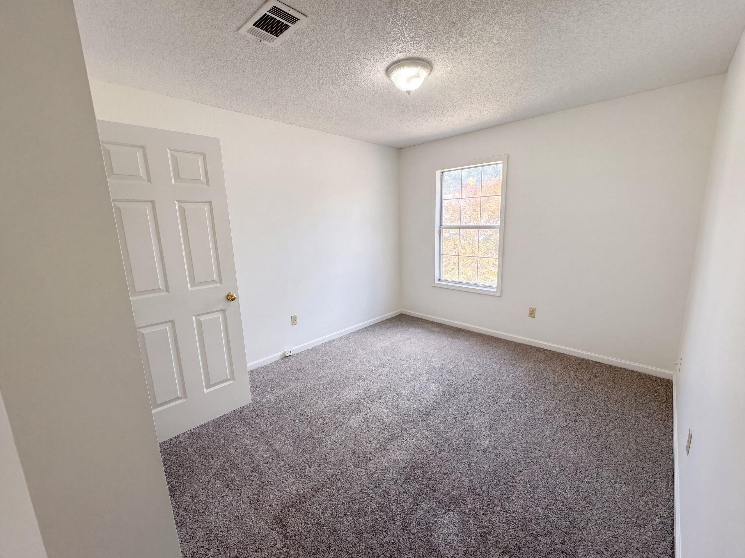 3798 Fern Ridge Road Memphis, TN 38115 - Photo 11 of 16 Room featuring light gray carpet, white painted walls, and a single window with white trim