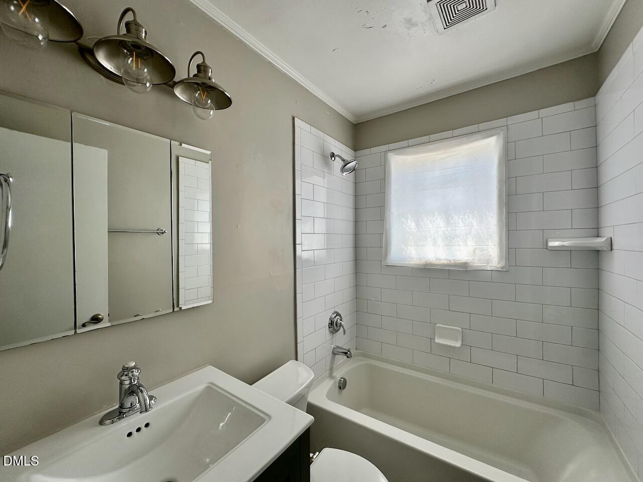 2333 Bernard Street Raleigh, NC 27608 - Photo 15 of 19 a bathroom with a sink a toilet and shower