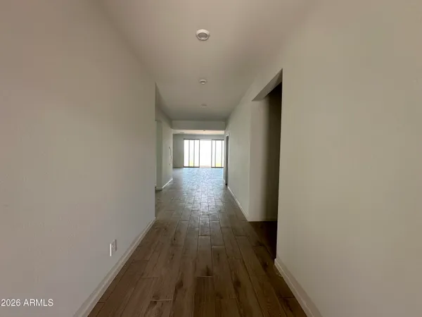 a view of hallway with wooden floor