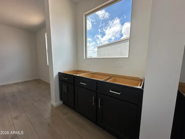 a room with painting on the wall and a window