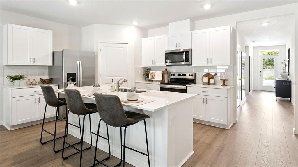 5276 Masser Road St. Cloud, FL 34772 - Photo 3 of 20 a kitchen with stainless steel appliances kitchen island granite countertop a sink and cabinets