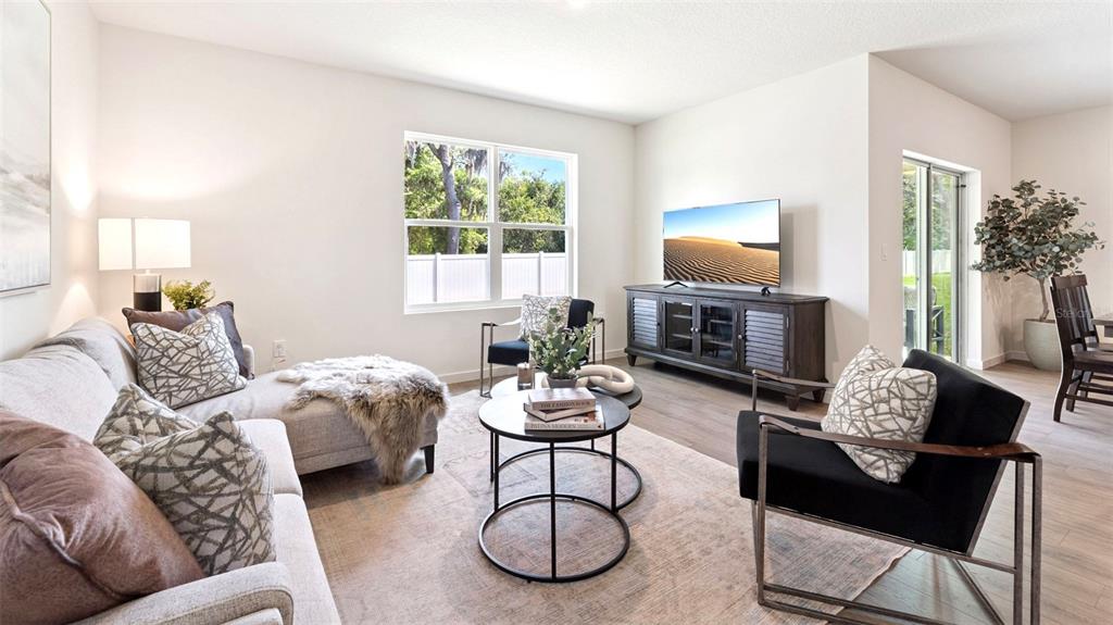 5276 Masser Road St. Cloud, FL 34772 - Photo 7 of 20 a living room with furniture a fireplace and a large mirror