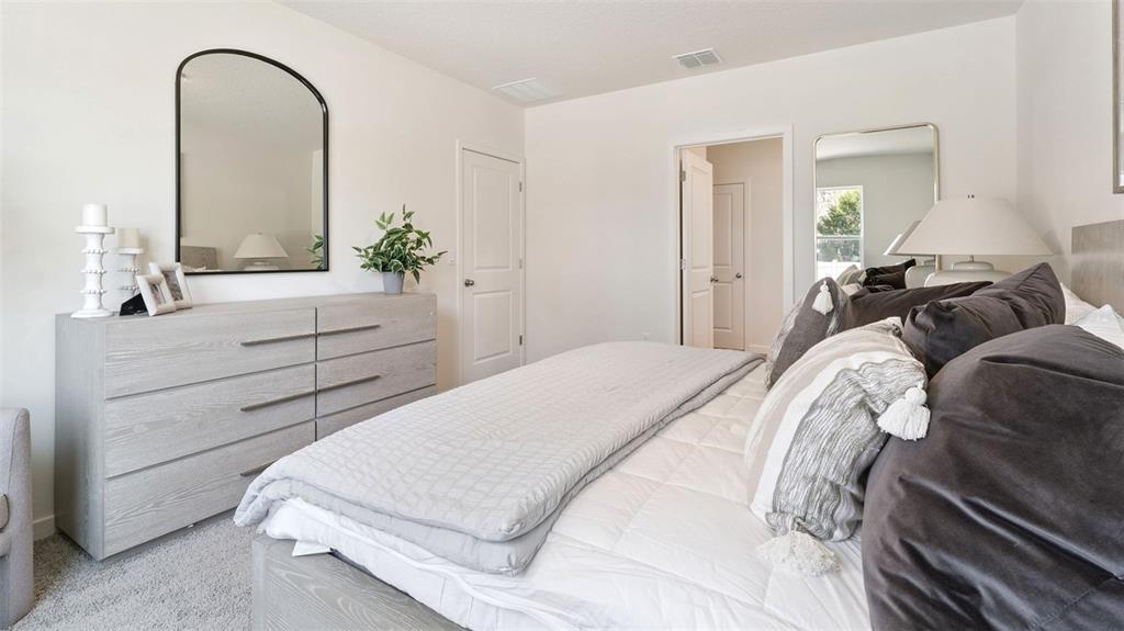 5276 Masser Road St. Cloud, FL 34772 - Photo 10 of 20 a bedroom with a bed and a dresser
