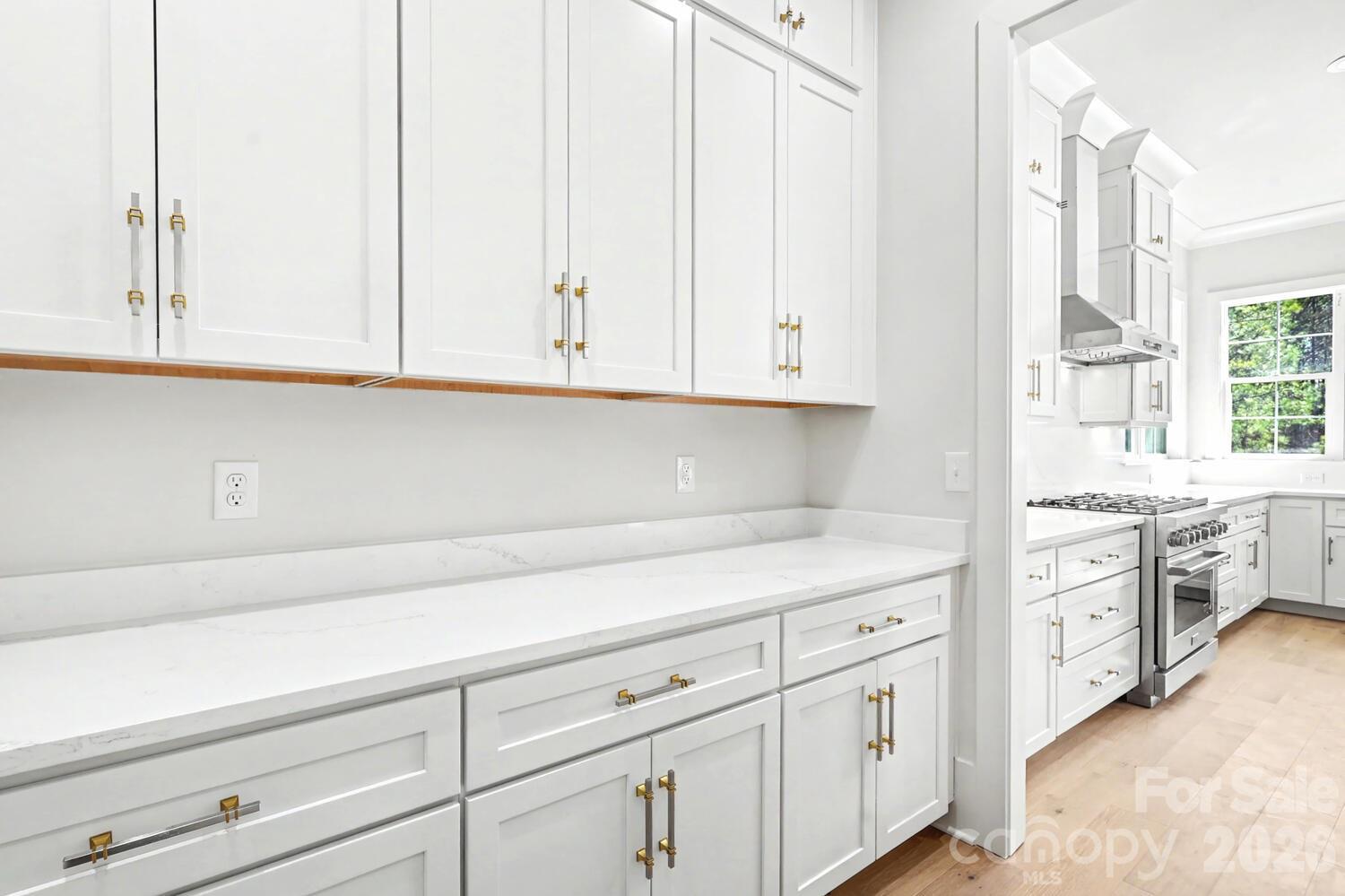 3210 Sherman Drive Lancaster, SC 29720 - Photo 17 of 44 a kitchen with white cabinets and a stove