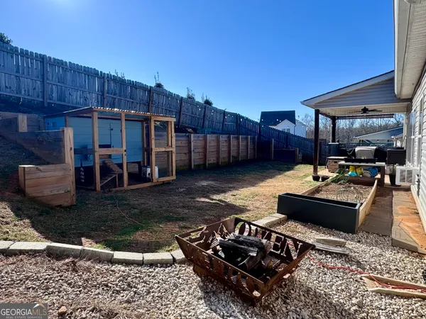 a view of a backyard with wooden floor patio and furniture