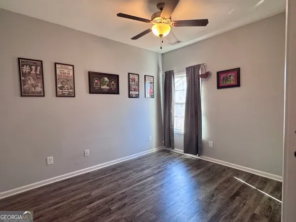 a view of a room with wooden floor and window