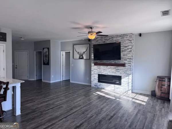 a living room with furniture a flat screen tv and a fireplace