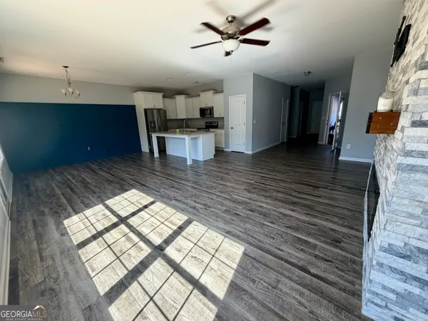 a kitchen view with wooden floor and outdoor space