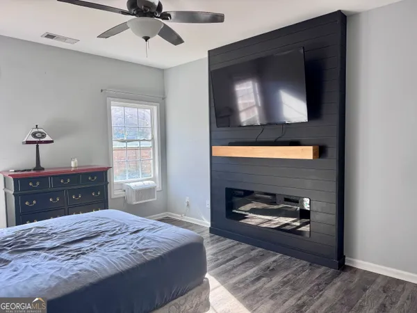 a bedroom with a bed and a dresser