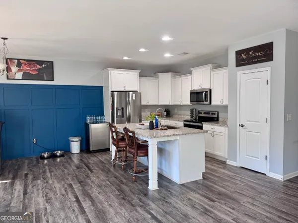 a kitchen with stainless steel appliances a refrigerator and a stove top oven