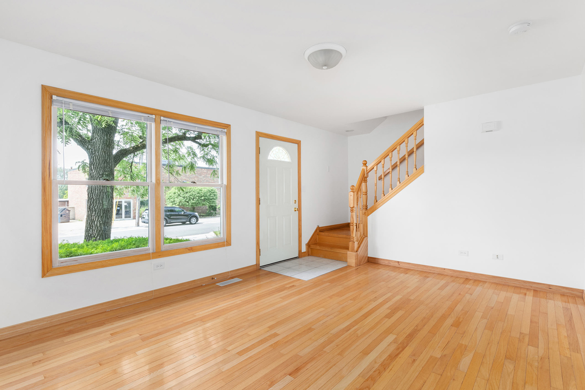 426 East 5th Street Lockport, IL 60441 - Photo 12 of 20 a view of an empty room with wooden floor and a window
