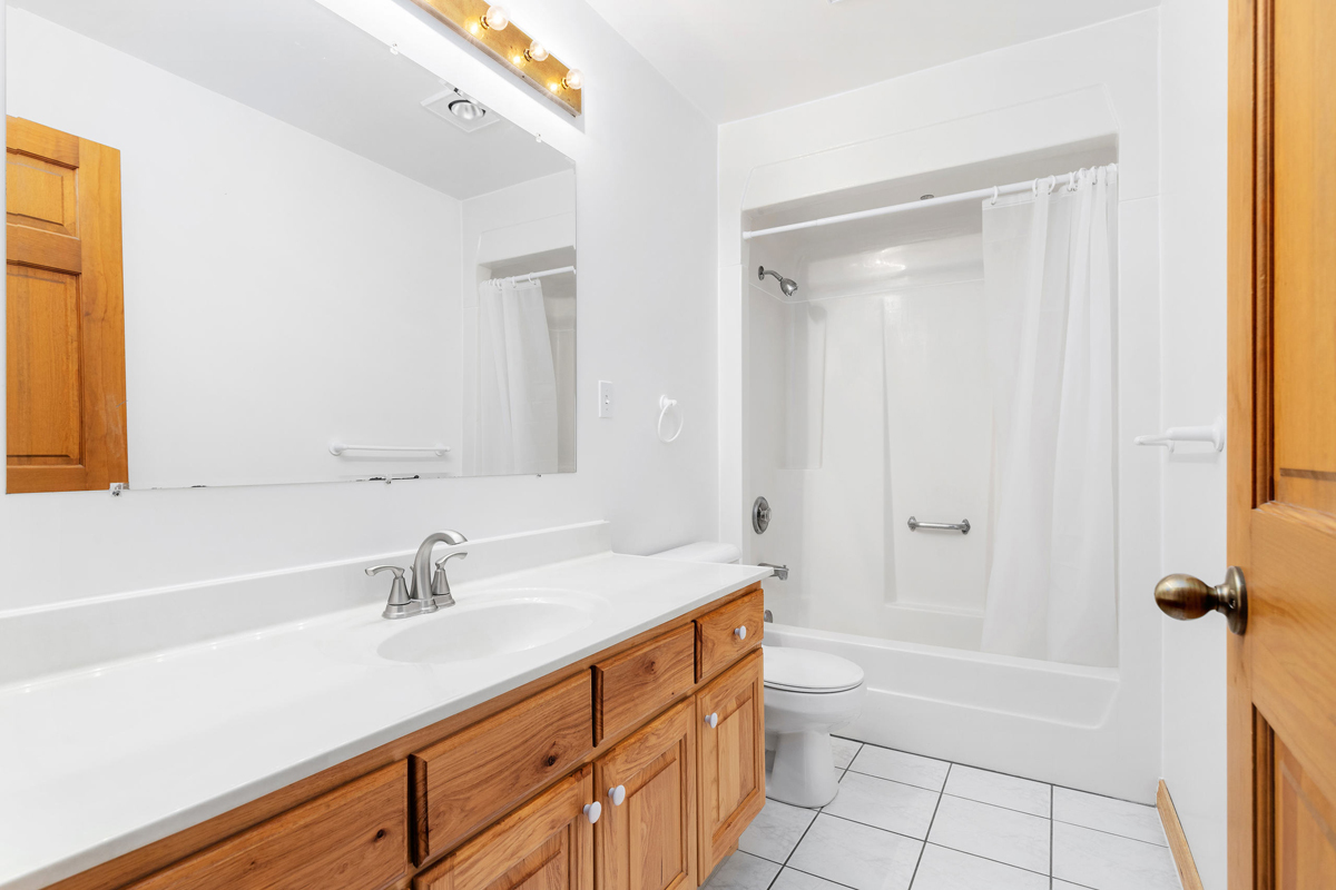 426 East 5th Street Lockport, IL 60441 - Photo 13 of 20 a bathroom with a sink a toilet and shower