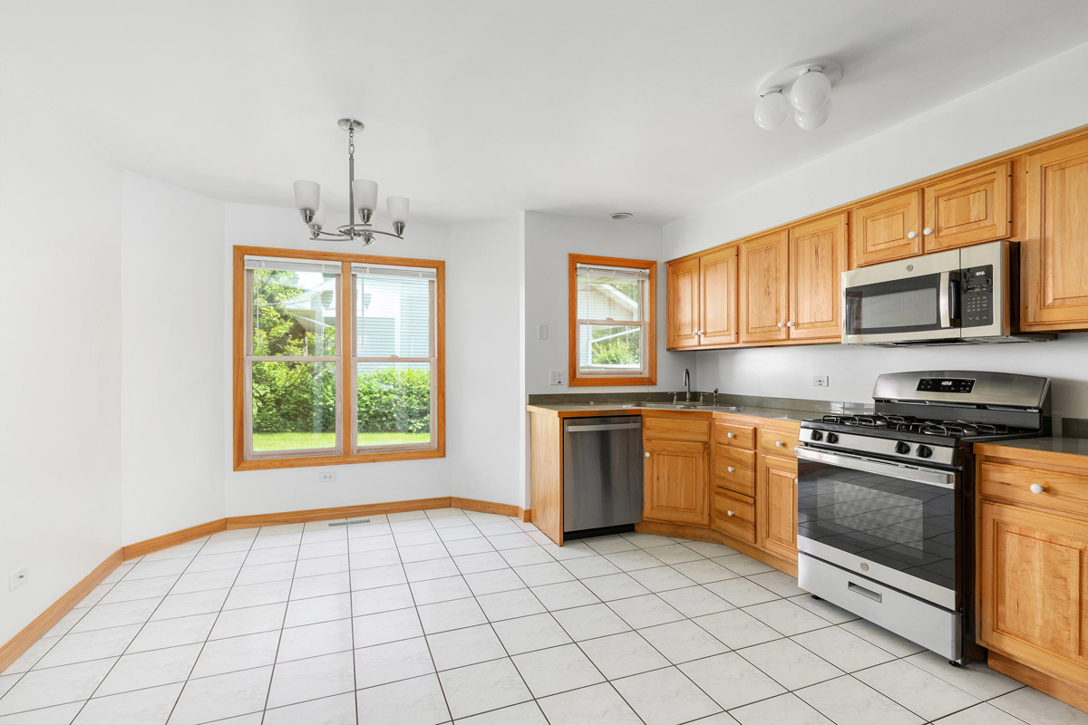 426 East 5th Street Lockport, IL 60441 - Photo 5 of 20 a kitchen with stainless steel appliances granite countertop a stove a sink and a microwave