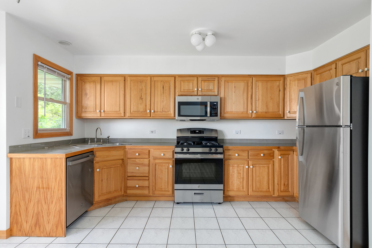 426 East 5th Street Lockport, IL 60441 - Photo 6 of 20 a kitchen with stainless steel appliances granite countertop a refrigerator and a stove top oven