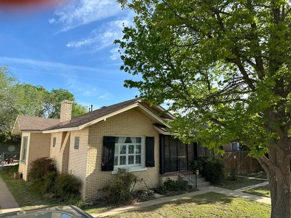a front view of a house with a yard garage and outdoor seating