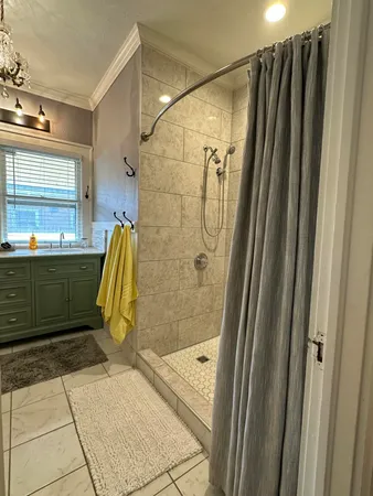 a bathroom with a shower and a sink