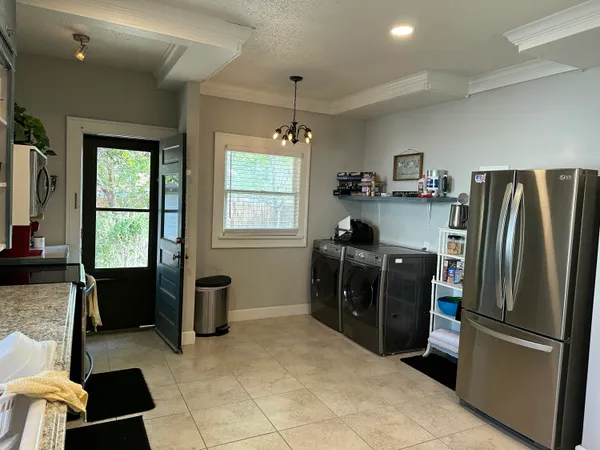 a kitchen with a refrigerator and a stove top oven
