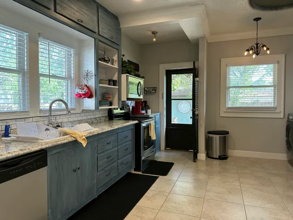 a kitchen with a sink stove and refrigerator