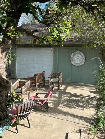 a view of a chairs and table in a backyard