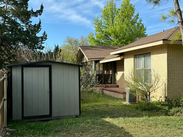 a view of a backyard with plants and a patio
