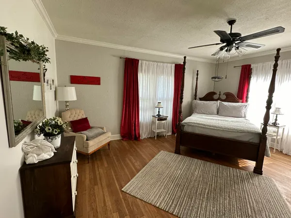 a bedroom with a bed and wooden floor