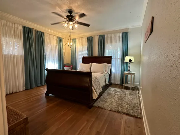 a bedroom with a bed and a chandelier