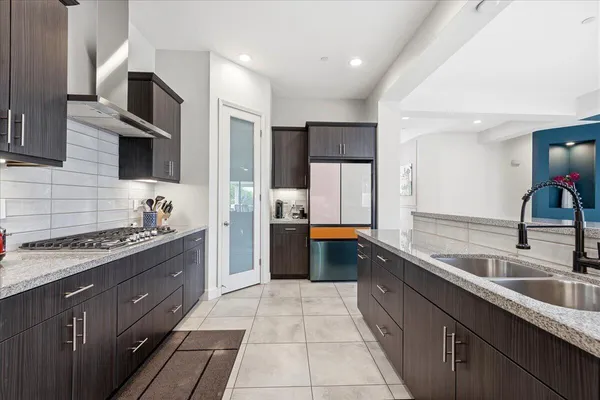 a view of a dining room with furniture wooden floor and chandelier