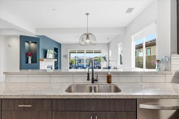 a large kitchen with stainless steel appliances granite countertop a sink and a stove