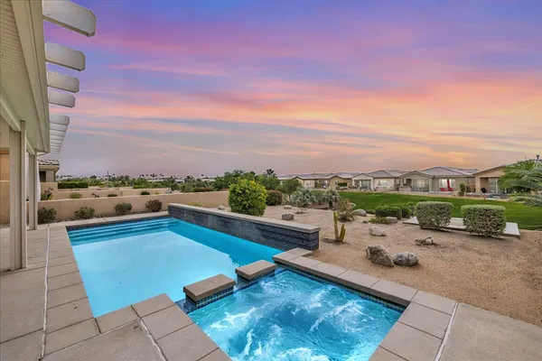 a view of a swimming pool and lounge chair