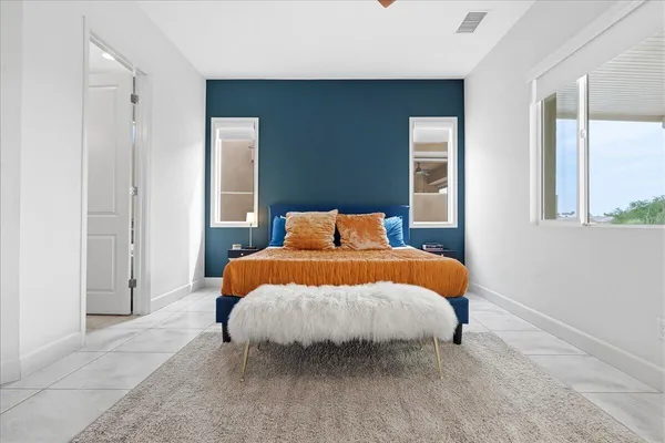 a bedroom with a bed and a window