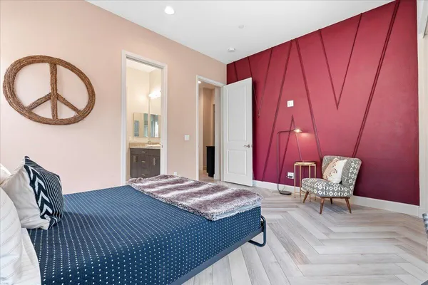 a spacious bedroom with a bed and window