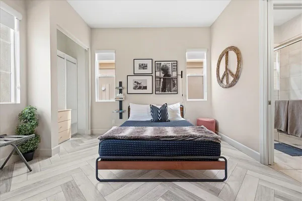 a living room with a bed furniture and a large window