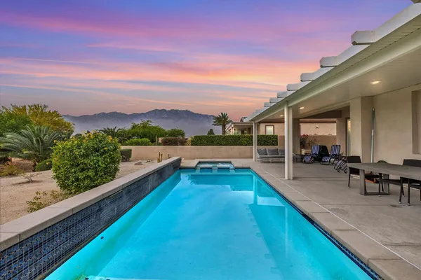 a view of a swimming pool with a lounge chair