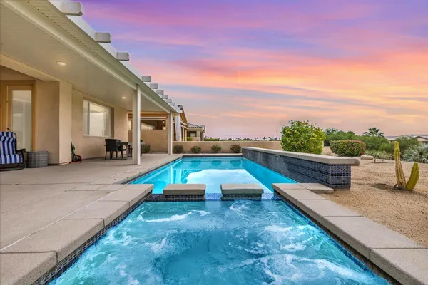 a view of a swimming pool with an outdoor seating