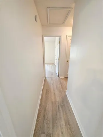 a view of a room with wooden floor