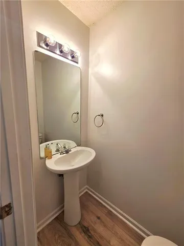 a bathroom with a sink a mirror and a toilet
