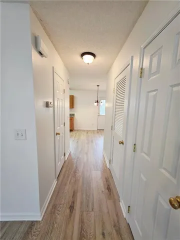 a view of a room with wooden floor