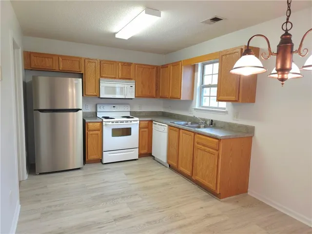 a kitchen with stainless steel appliances granite countertop a refrigerator sink and cabinets