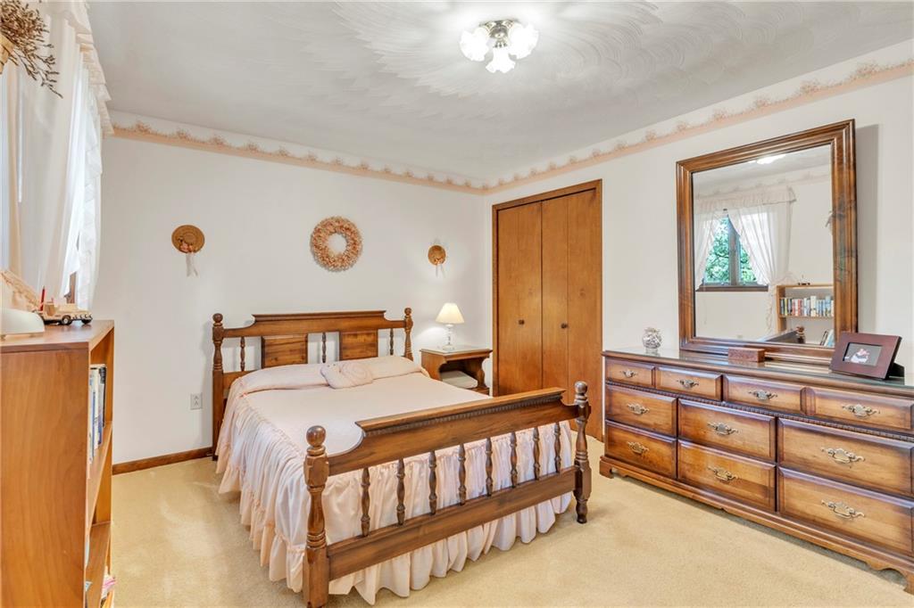 454 Cherokee Drive Butler, PA 16001 - Photo 19 of 31 a bedroom with a bed and a chandelier