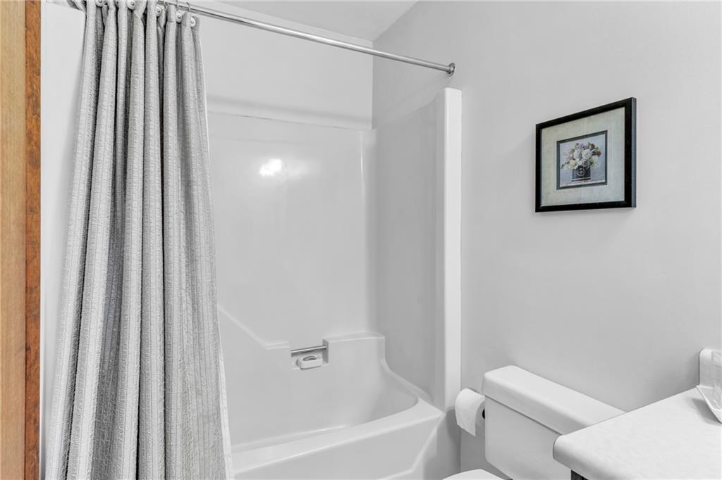 454 Cherokee Drive Butler, PA 16001 - Photo 26 of 31 a white toilet sitting next to a bath tub