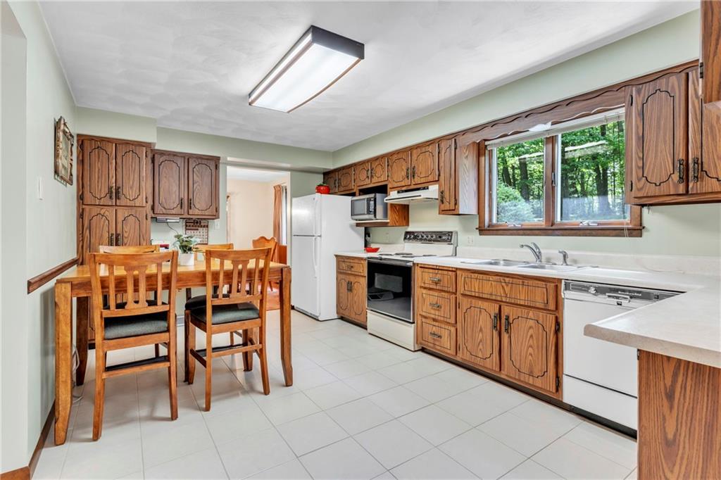 454 Cherokee Drive Butler, PA 16001 - Photo 10 of 31 a kitchen with stainless steel appliances granite countertop a table chairs sink and window