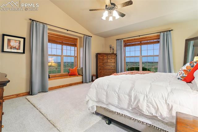5470 Roundup Ridge Road Colorado Springs, CO 80908 - Photo 9 of 21 Carpeted bedroom with ceiling fan and lofted ceiling