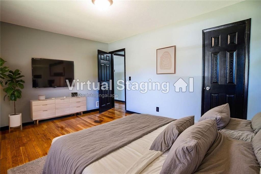 2877 Whispering Hills Drive, Unit 2875 Atlanta, GA 30341 - Photo 12 of 18 a bedroom with a bed and wooden floor