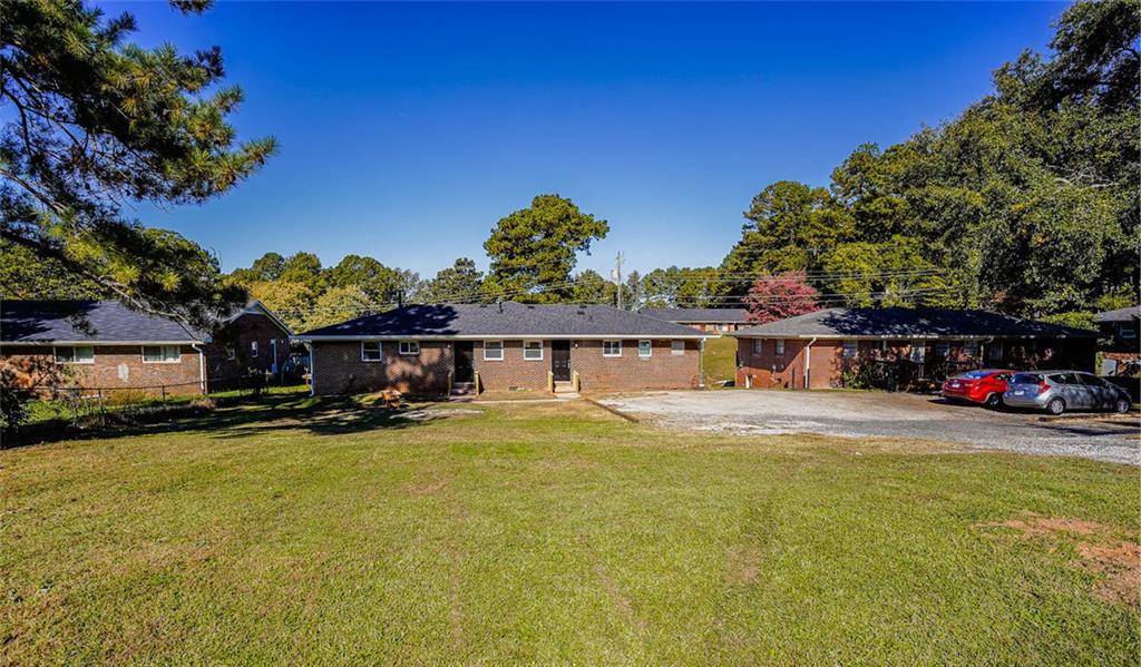2877 Whispering Hills Drive, Unit 2875 Atlanta, GA 30341 - Photo 17 of 18 a view of a house with a patio and a yard