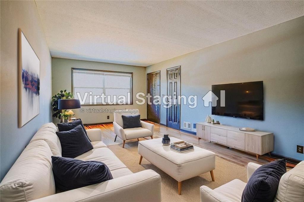 2877 Whispering Hills Drive, Unit 2875 Atlanta, GA 30341 - Photo 2 of 18 a living room with furniture and a flat screen tv